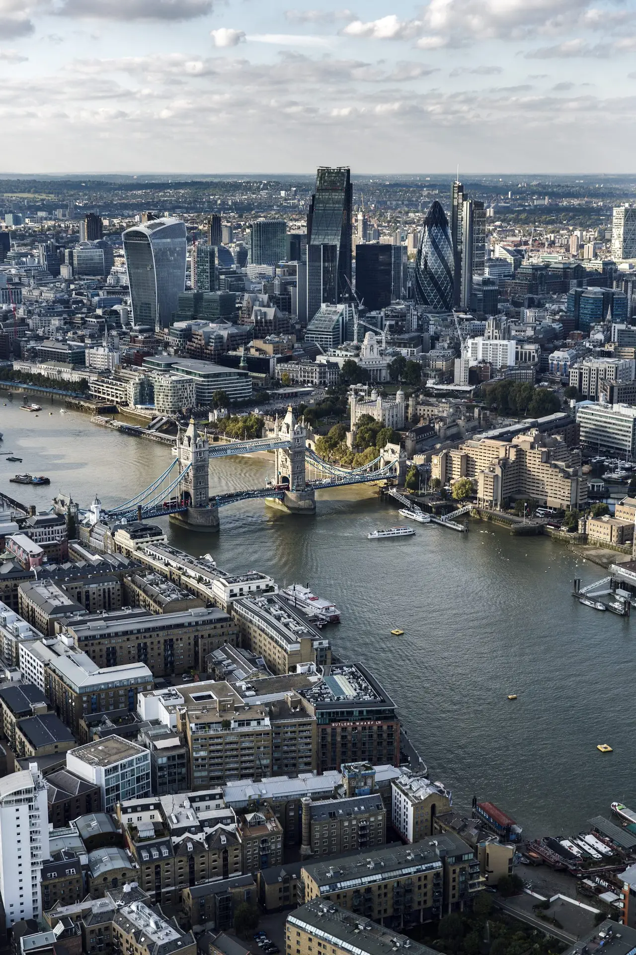 Aerial view of a bustling cityscape with iconic bridges and skyscrapers